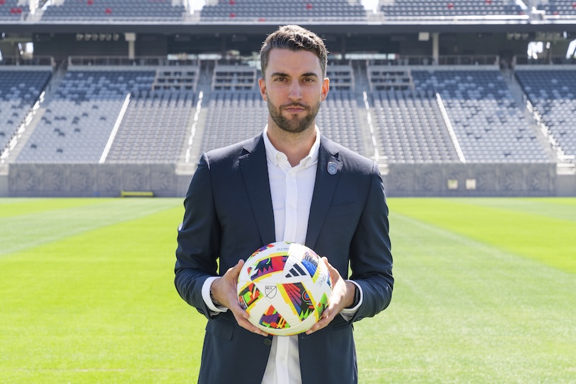 San Diego FC sporting director Tyler Heaps holding a soccer ball